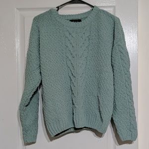 Crochet sweater with braided line in middle.